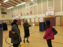 Physical Education teacher, Rick Mortlock, discusses the disaster plan of his elementary school with Marina Inagaki and Kiriko Takahashi.